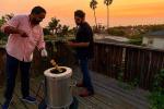 Cooking skewers on a GULATI home tandoor at sunset