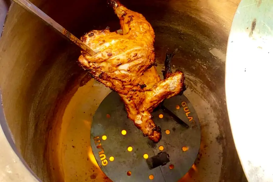 Tandoori chicken roasting above a GULATI TandoorDISC plate